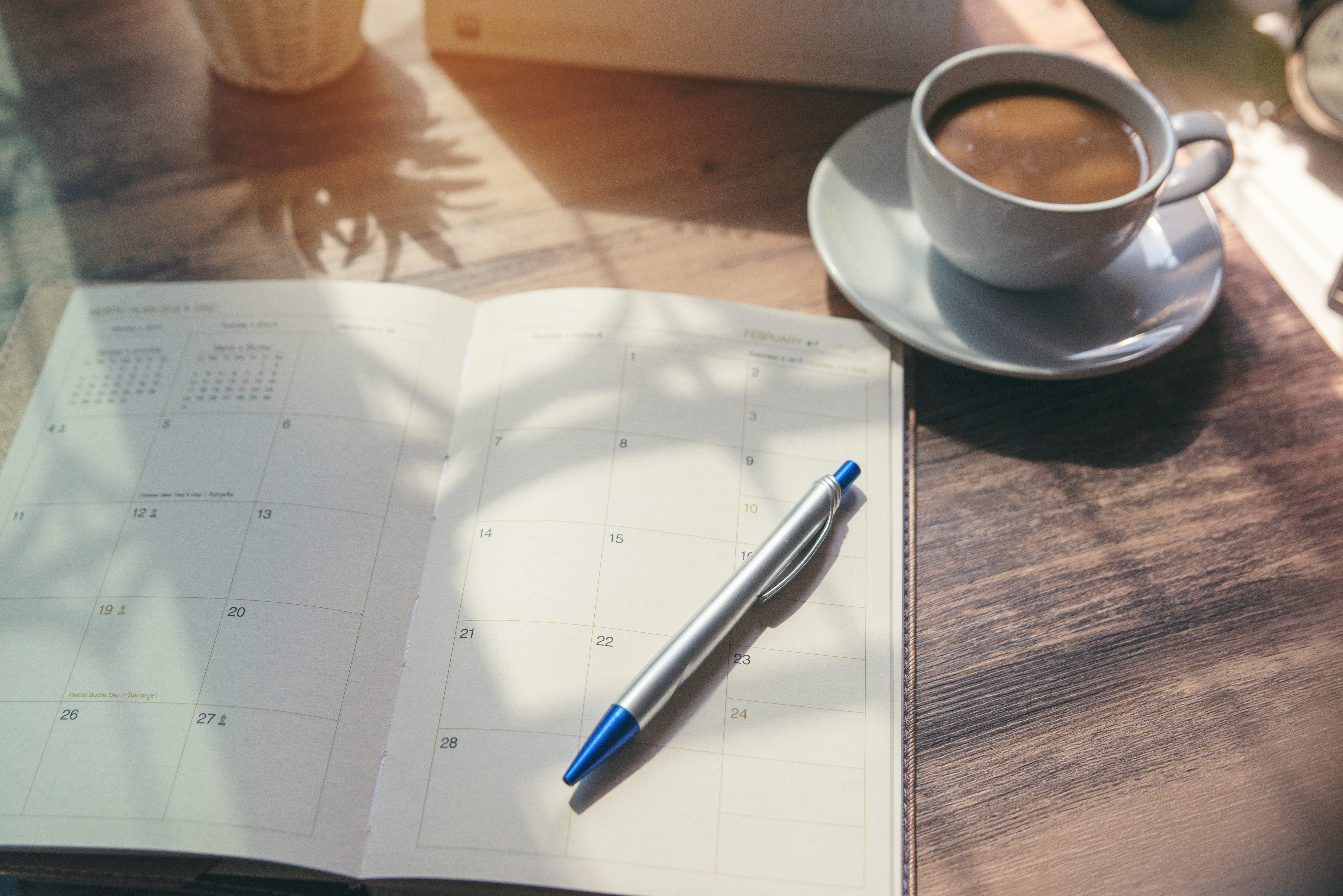 planner on a table with some coffee