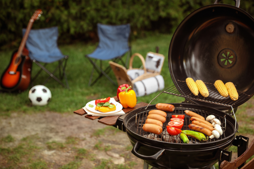 barbecue in the back yard with chairs with soccer ball and chairs