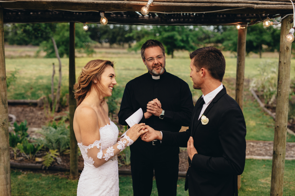 bride reading her vows under the alter to her groom