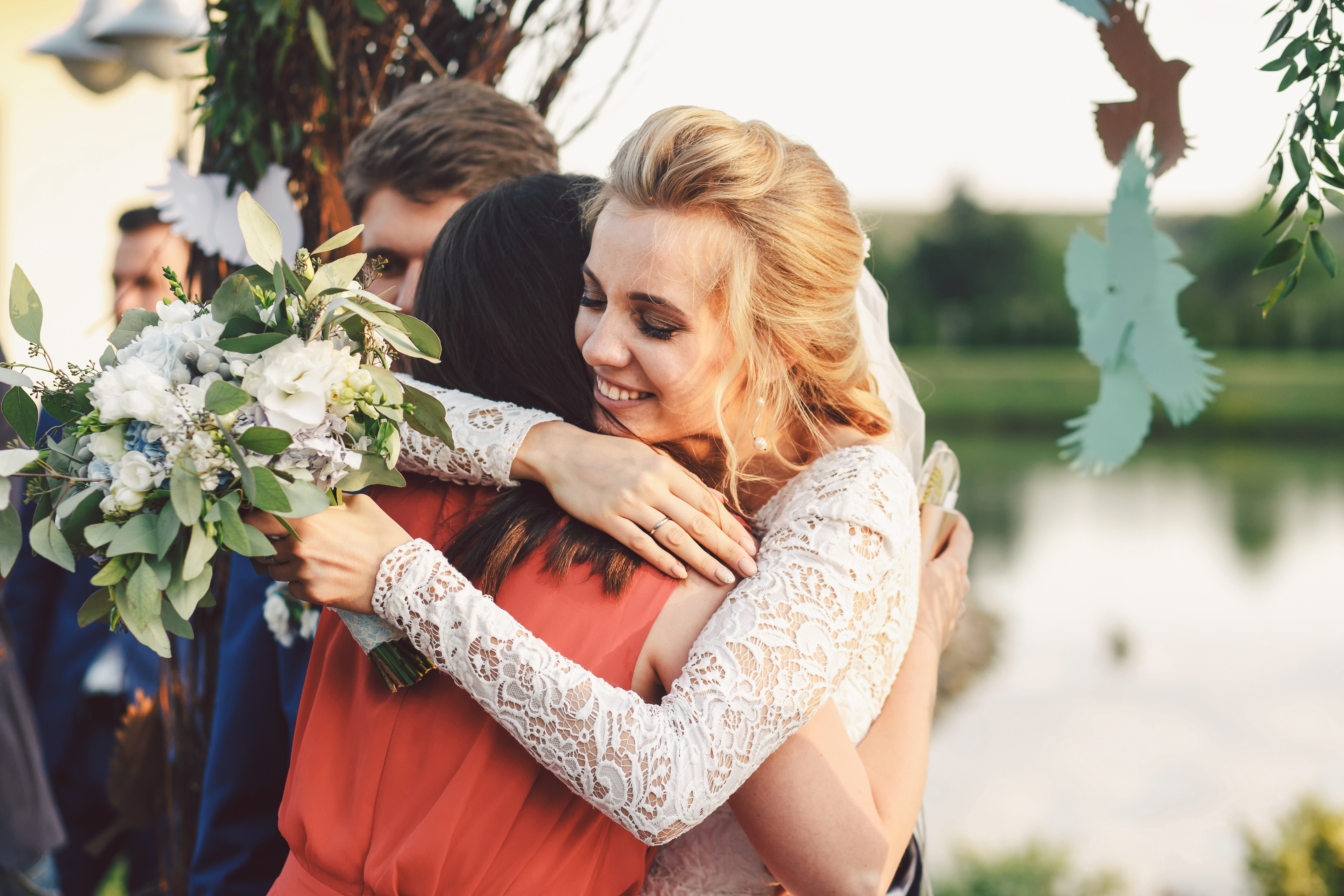 bride hugging a girl friend at her wedding