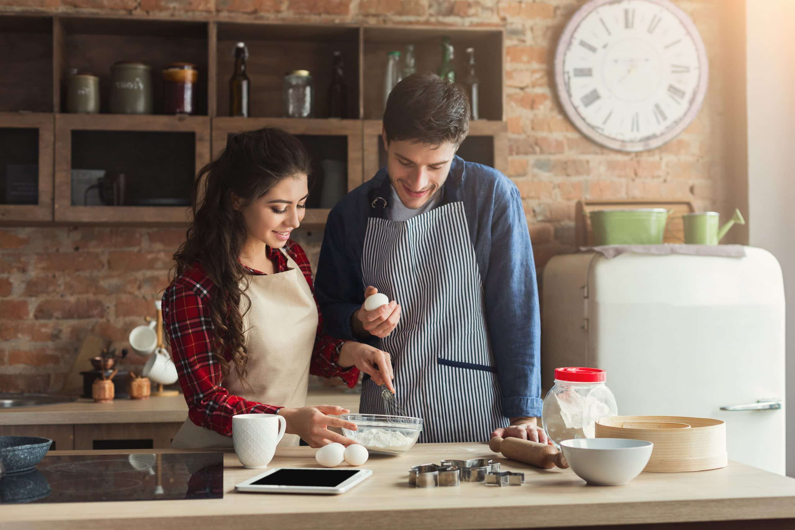  young couple baking together at home