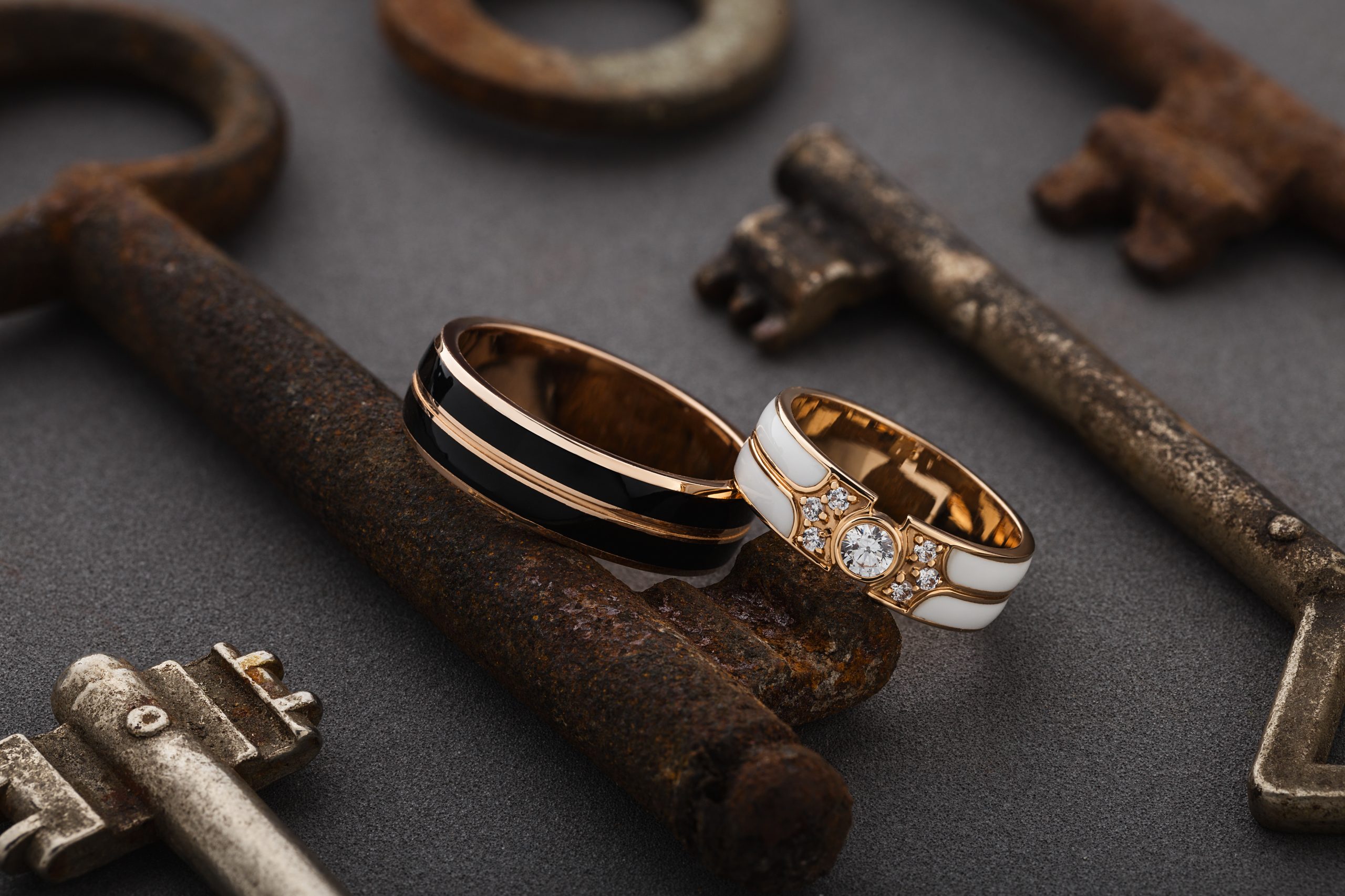 wedding ring on top of rusted keys on a table