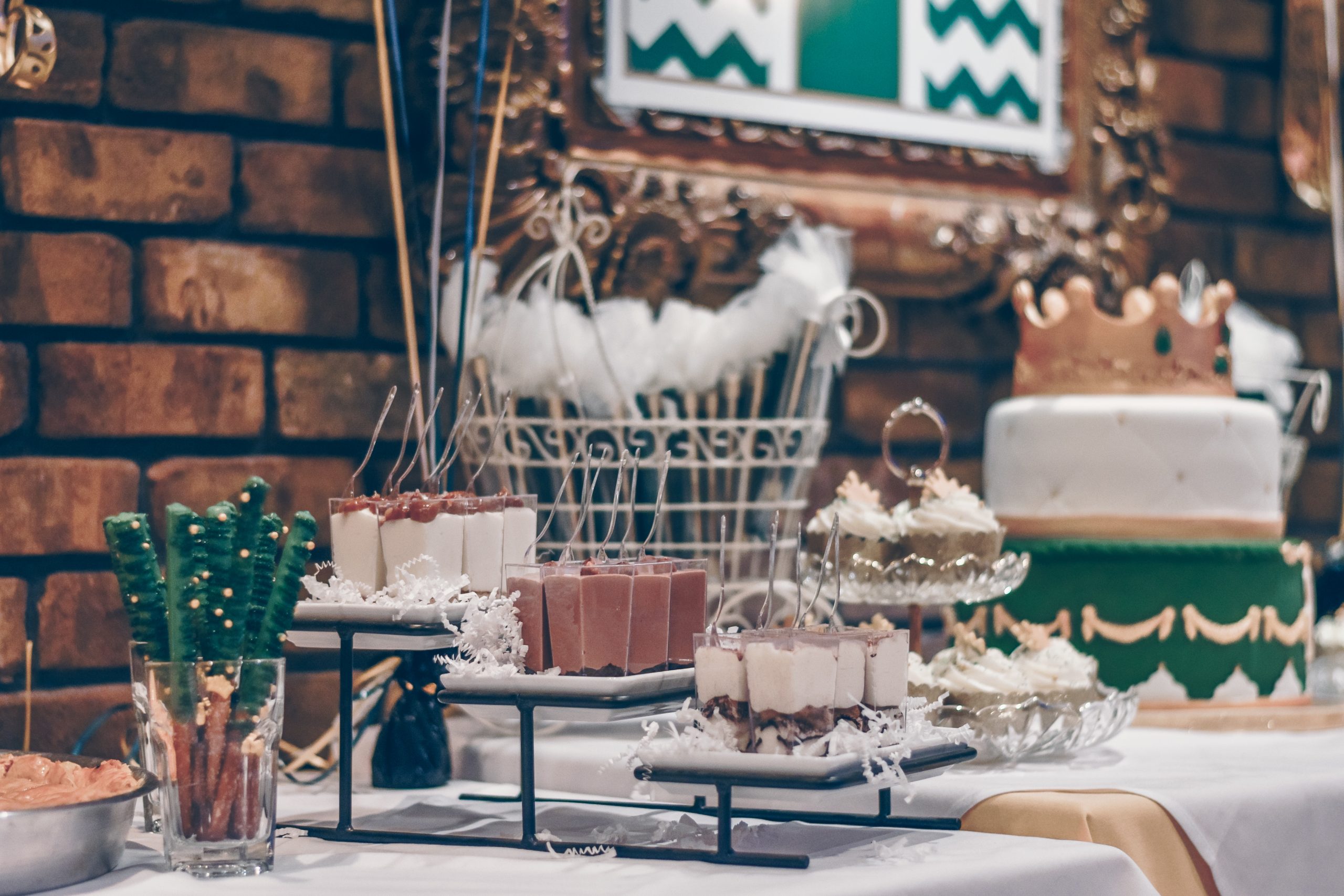 Decorations and food on a table at a gender reveal party.